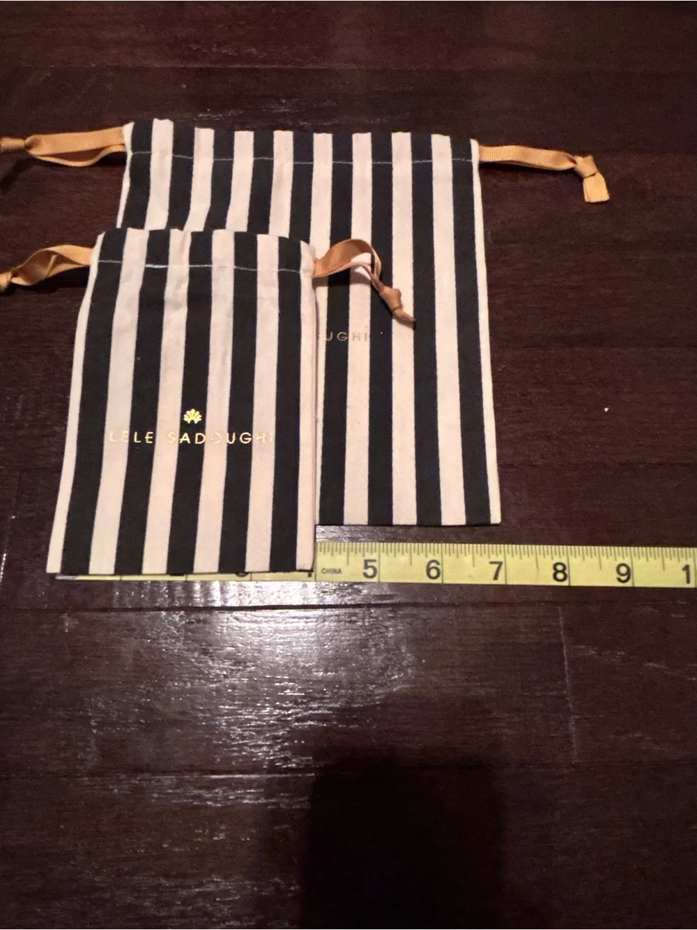 Lele Sadoughi Black and White Striped Drawstring Pouches with Gold Logo